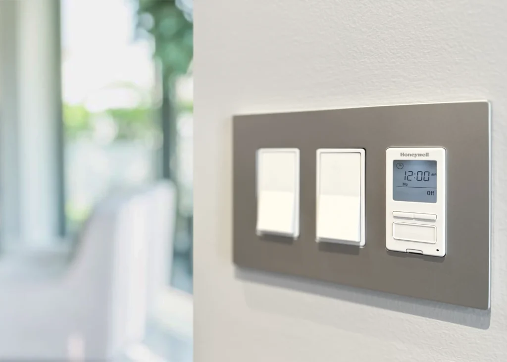 Smart, programmable smart home technology light switch by honeywell installed on a wall