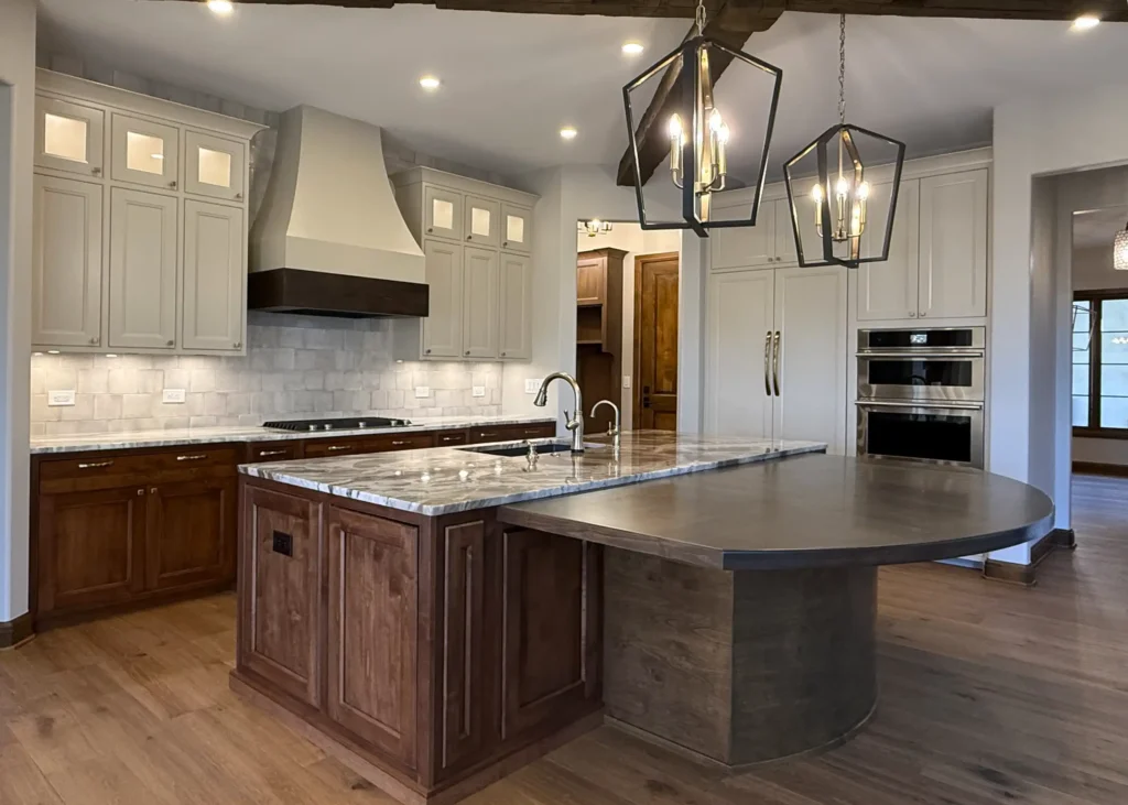 Combining countertop materials can bring warmth to your space. Think about incorporating a wood dining counter for entertaining.