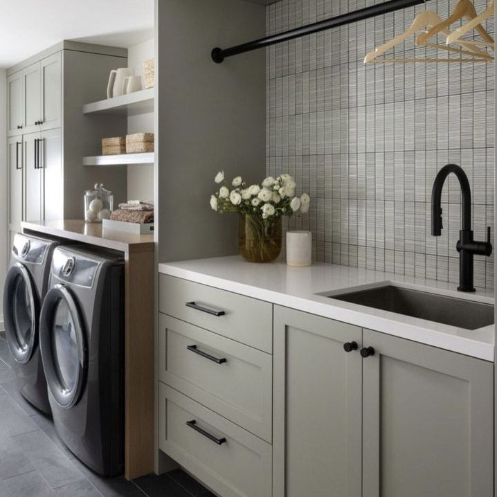 Who says laundry can’t be stylish? A soft sage palette, sleek black hardware, and thoughtful organization turn this space into a serene, functional retreat.Screenshot